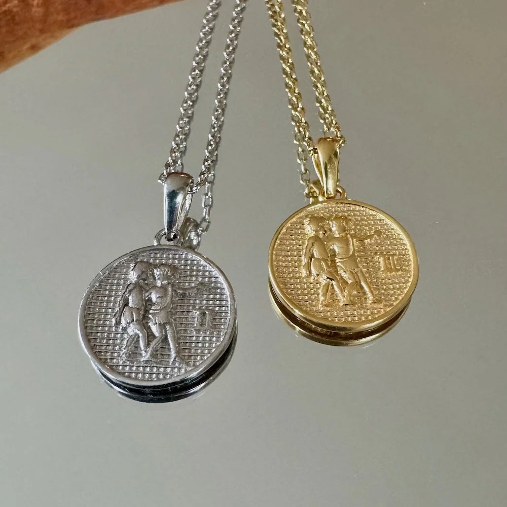 Elegant gold and silver zodiac pendants featuring a Gemini design, perfect for women or unisex styles on any occasion.
