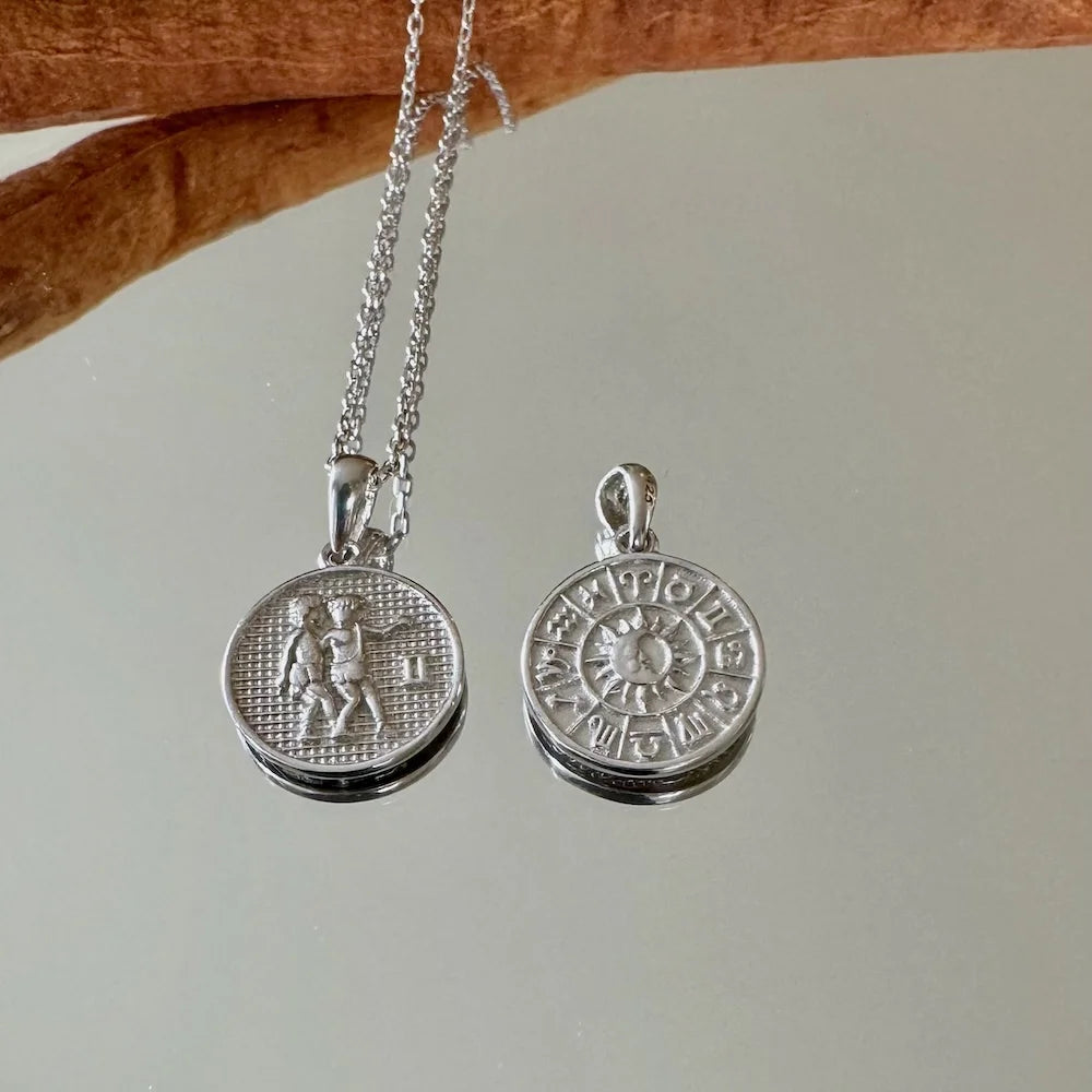 Silver zodiac charm necklace perfect for women, featuring intricate astrological designs for a stylish, celestial touch.
