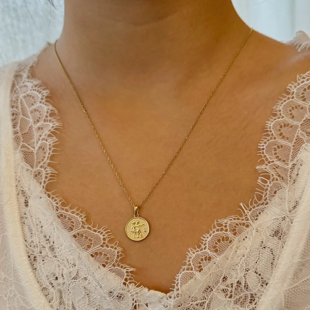 Gold pendant necklace with intricate design, perfect for women seeking minimalist, chic style for everyday wear.