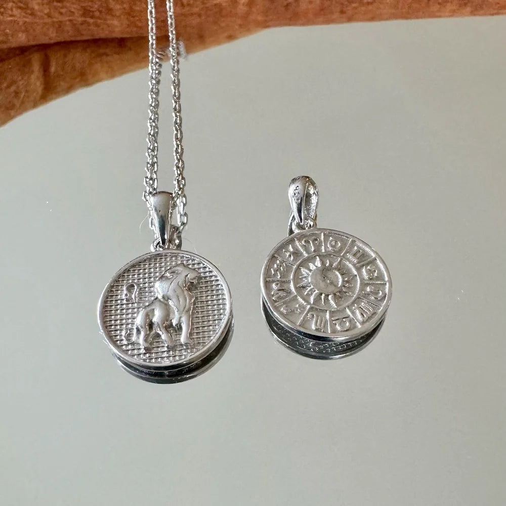 Sterling silver zodiac pendant necklace featuring lion and celestial designs, perfect for astrology lovers and everyday wear.