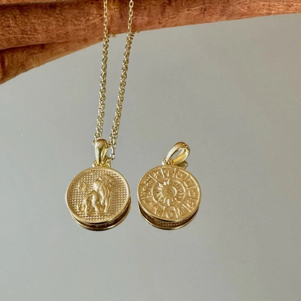 Gold zodiac pendants on a delicate chain, perfect for women seeking a bohemian touch to their jewelry collection.
