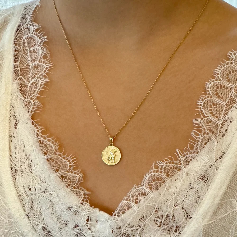 Delicate gold pendant necklace perfect for women, featuring a vintage-inspired coin design, ideal for casual or festive occasions.