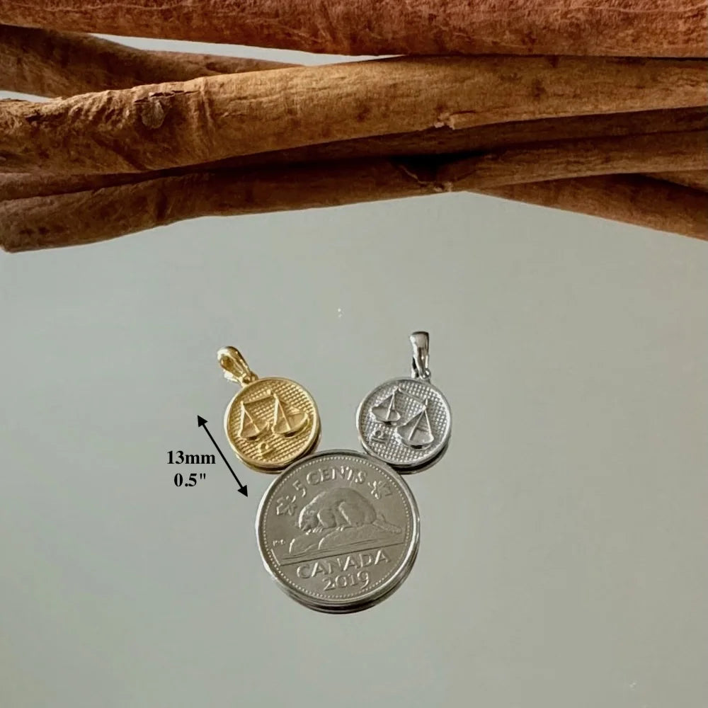 Gold and silver balance scale pendants, perfect for women seeking minimalist, meaningful jewelry styles.