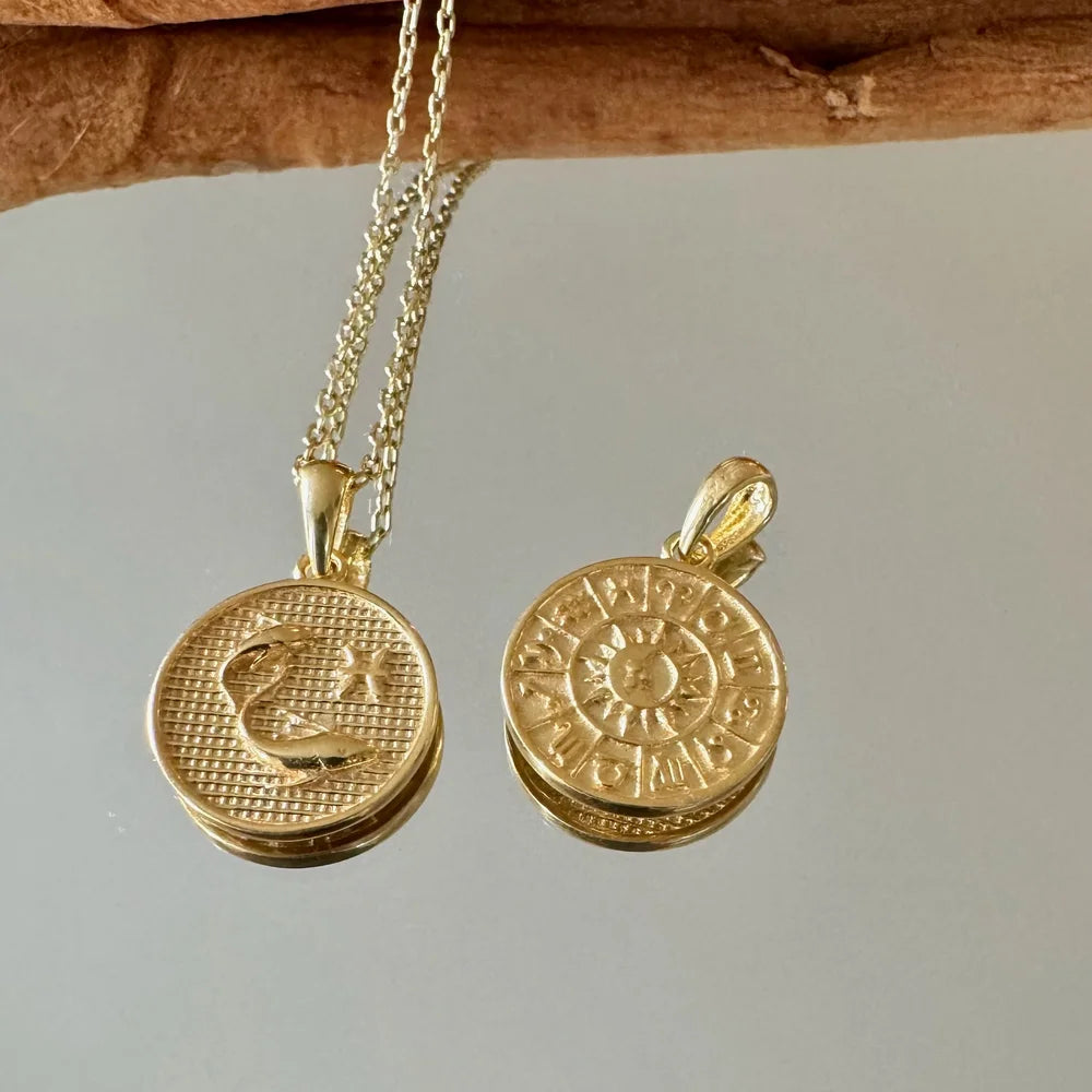 Gold zodiac pendant necklaces for women, featuring intricate designs, perfect for bohemian-inspired outfits or special occasions.