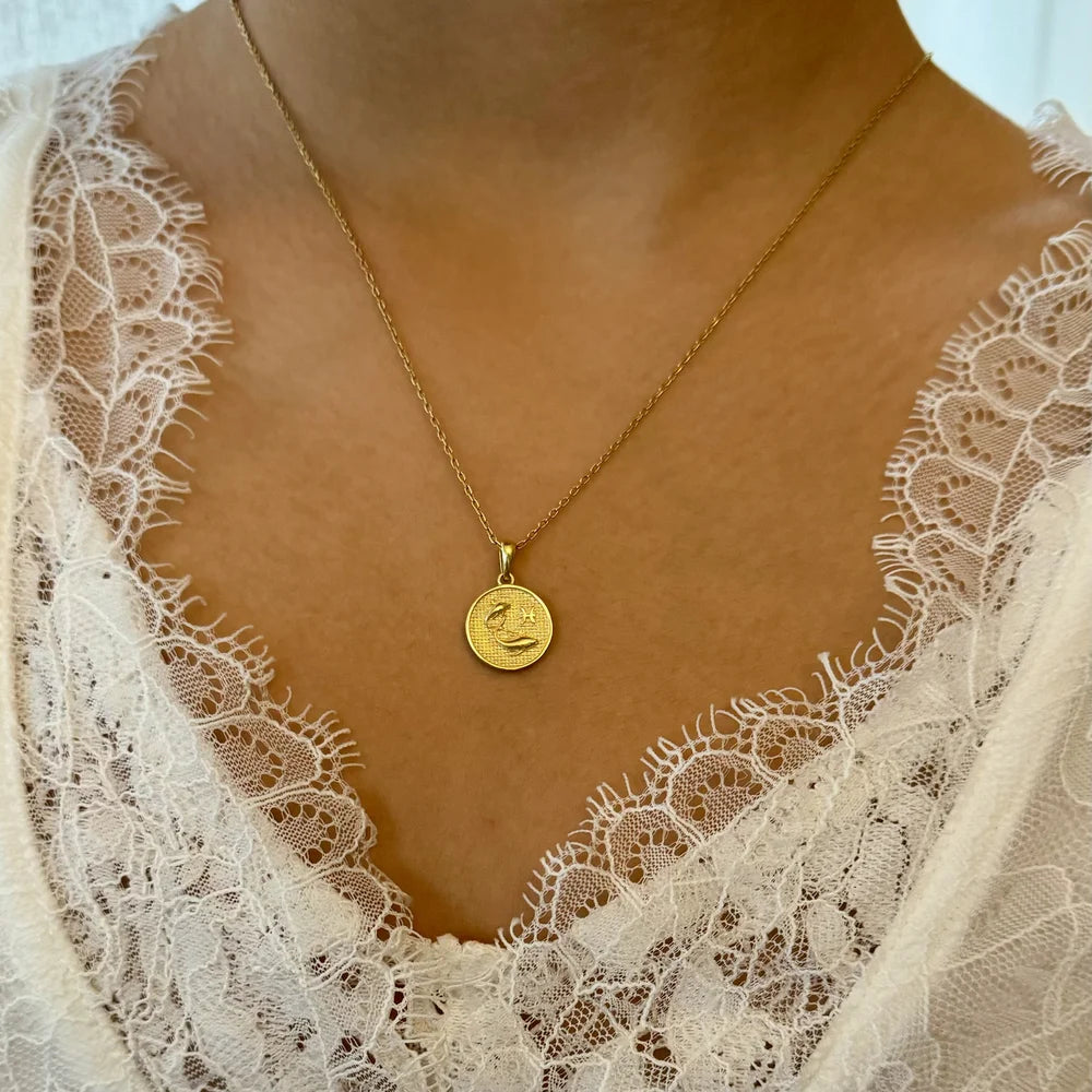 Gold pendant necklace featuring a textured round charm, perfect for women seeking a minimalist and elegant look.