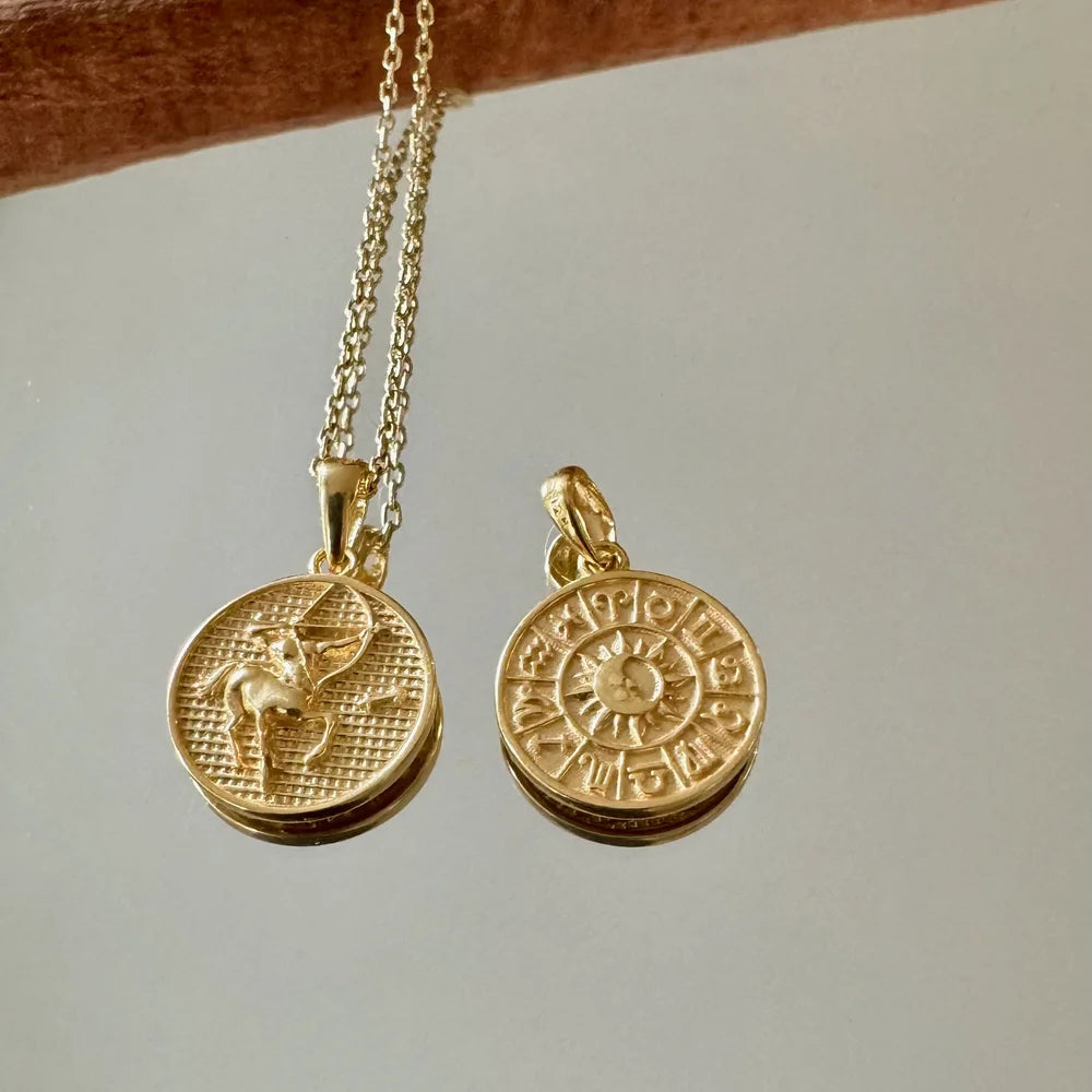 Gold zodiac pendant necklace for women, featuring astrology symbols and a minimalist design ideal for everyday wear.