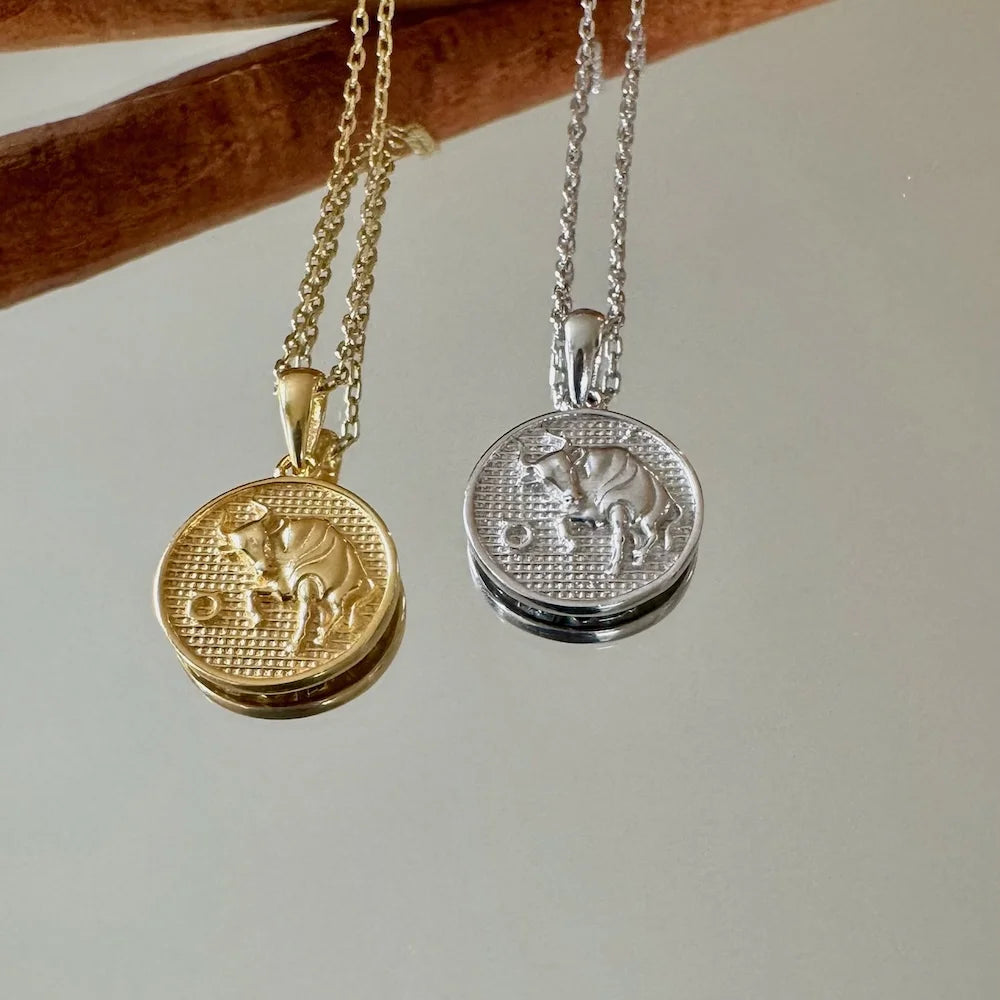 Gold and silver zodiac animal pendants on chains, perfect for women who love minimalist and astrological jewelry.