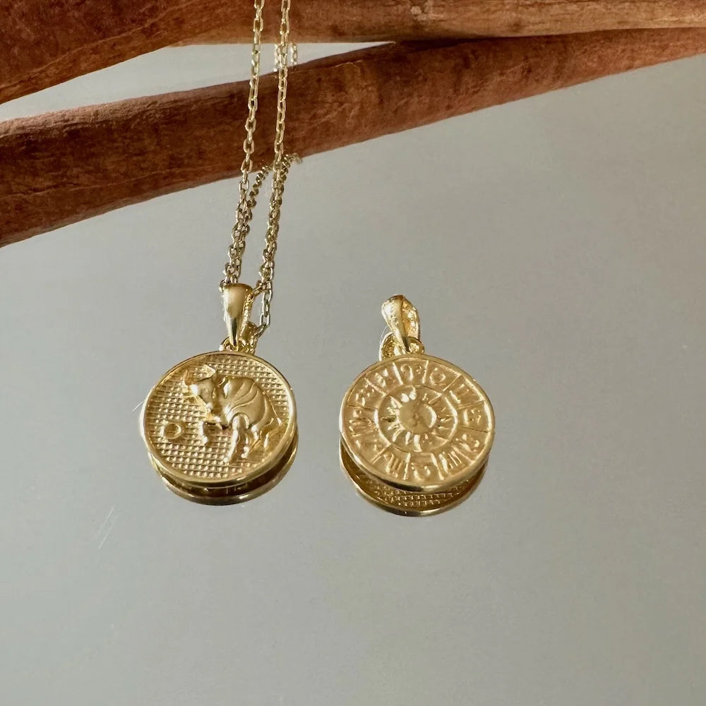 Gold zodiac pendant necklace, featuring intricate designs, perfect for women seeking a unique, bohemian style accessory.