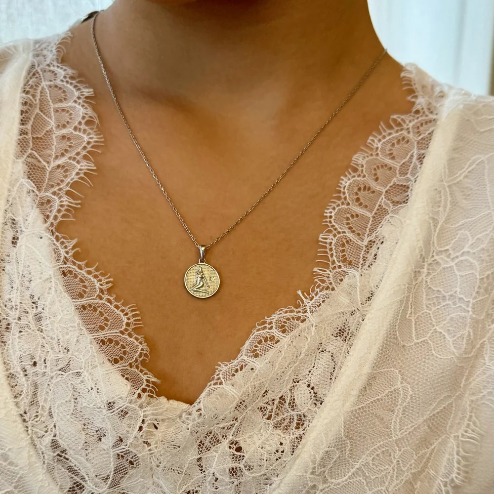 Silver pendant necklace featuring a vintage coin design, perfect for women seeking classic elegance.