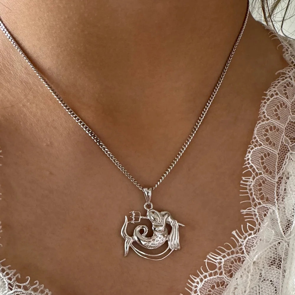 Silver mermaid necklace on a delicate chain, perfect for women who love whimsical and classic jewelry styles.