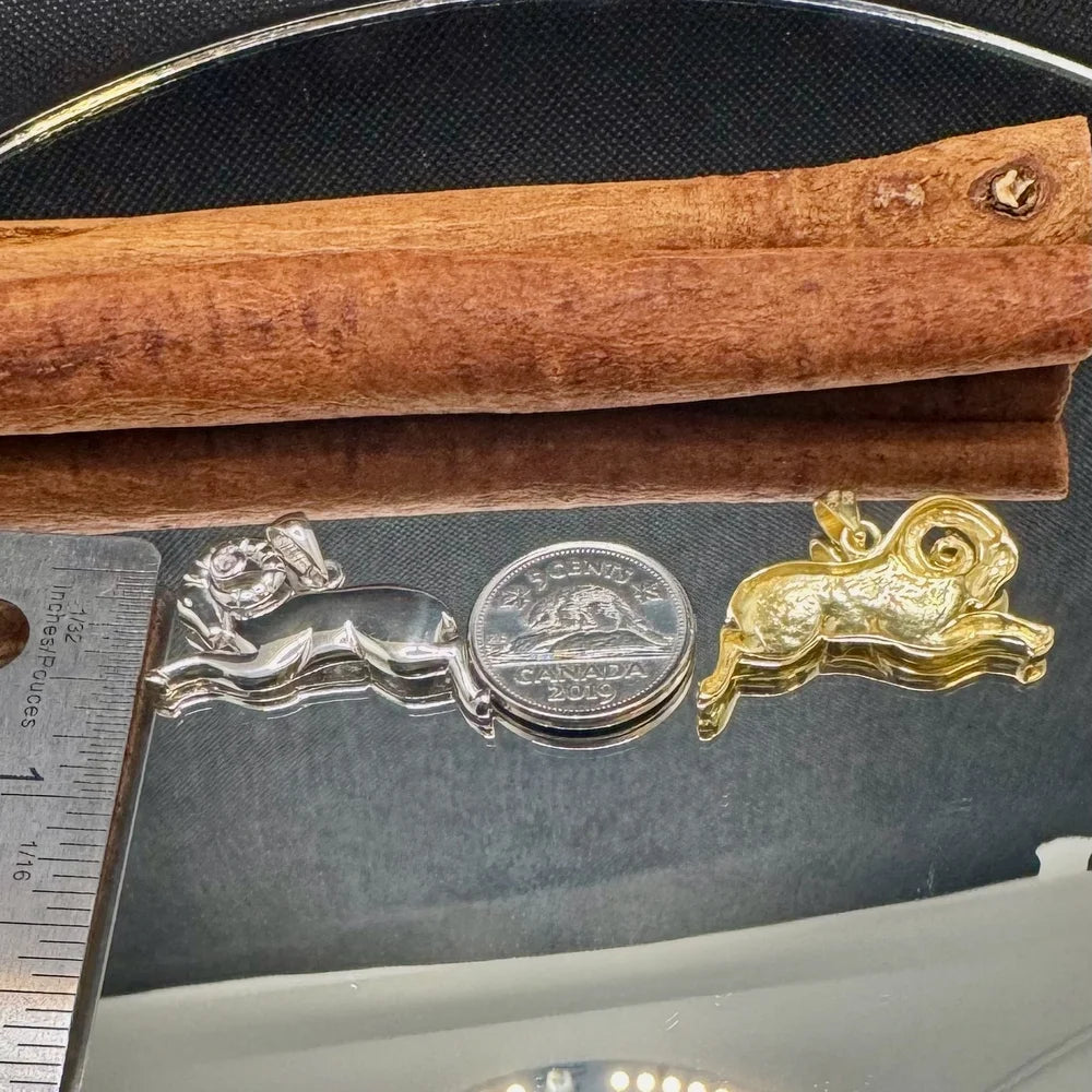 Silver rabbit and gold ram charms, perfect for animal lovers; ideal for unisex jewelry collection and playful style.