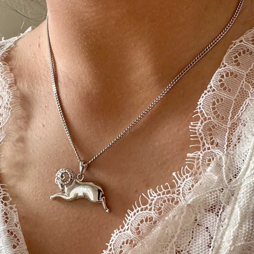 Silver ram pendant necklace on a delicate chain, perfect for women seeking minimalist, zodiac-themed jewelry.