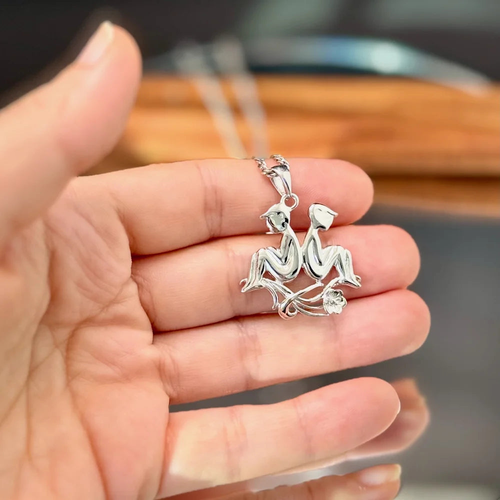 Silver couple pendant necklace, perfect for unisex wear. Ideal for romantic occasions and stylish everyday outfits.