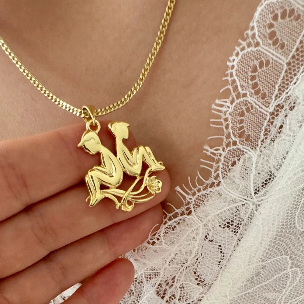 Gold minimalist pendant necklace featuring two seated figures, ideal for women seeking unique and stylish jewelry.