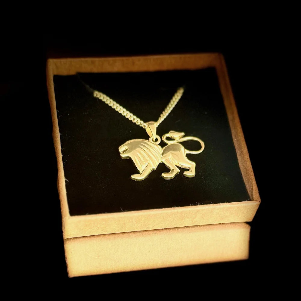 Gold lion pendant necklace on a delicate chain, perfect for men and women; embodies strength and style for any occasion.