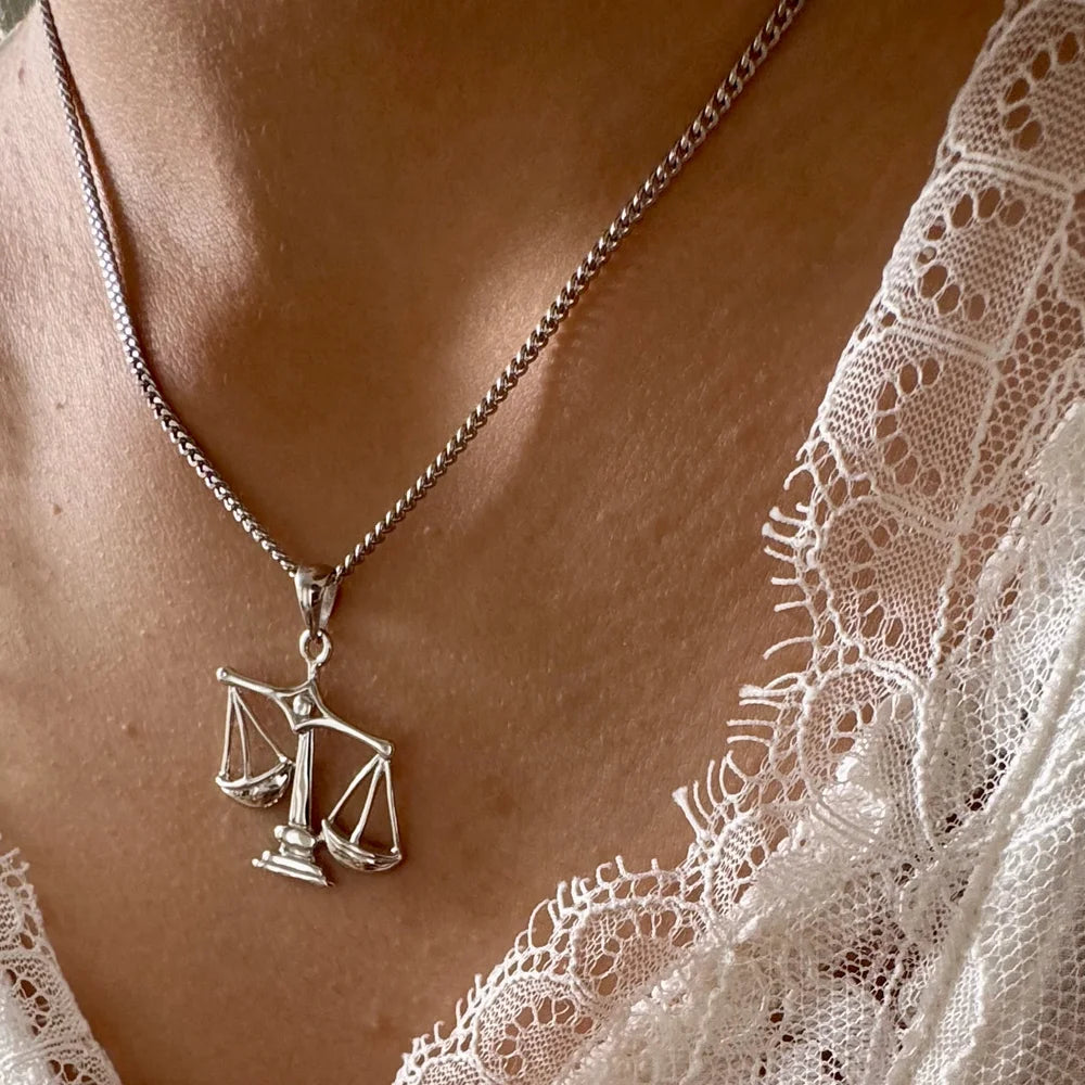 Sterling silver scale necklace for women, ideal for minimalist style and special occasions, showcasing elegance and balance.
