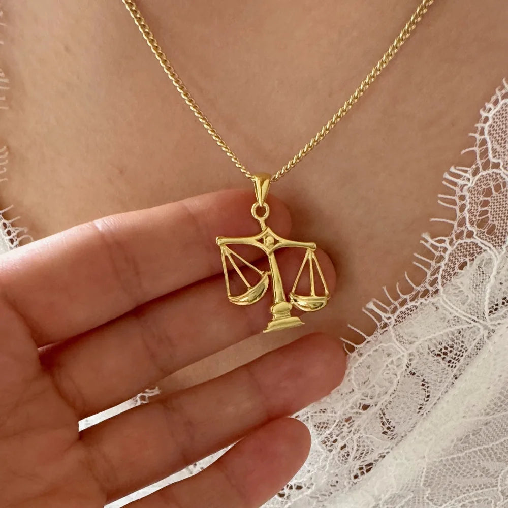 Gold scales necklace pendant, elegant design perfect for women, ideal for casual or legal-themed occasions.