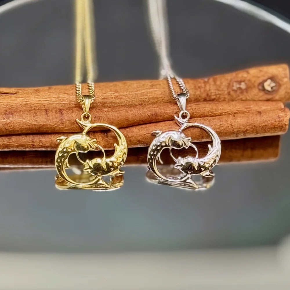 Dolphin pendant necklaces in gold and silver, perfect for women who appreciate minimalist coastal jewelry.