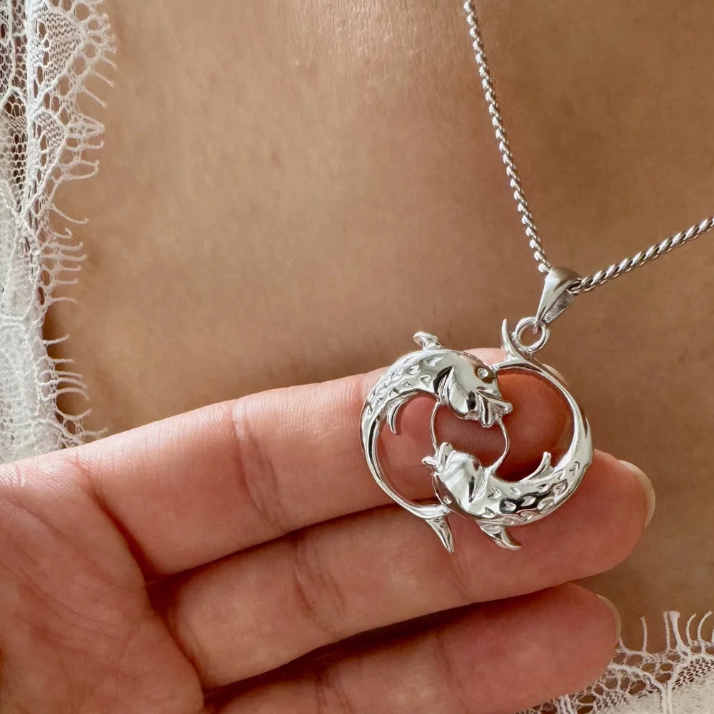 Sterling silver dolphin pendant necklace, ideal for women seeking a minimalist, ocean-themed accessory for casual outings.