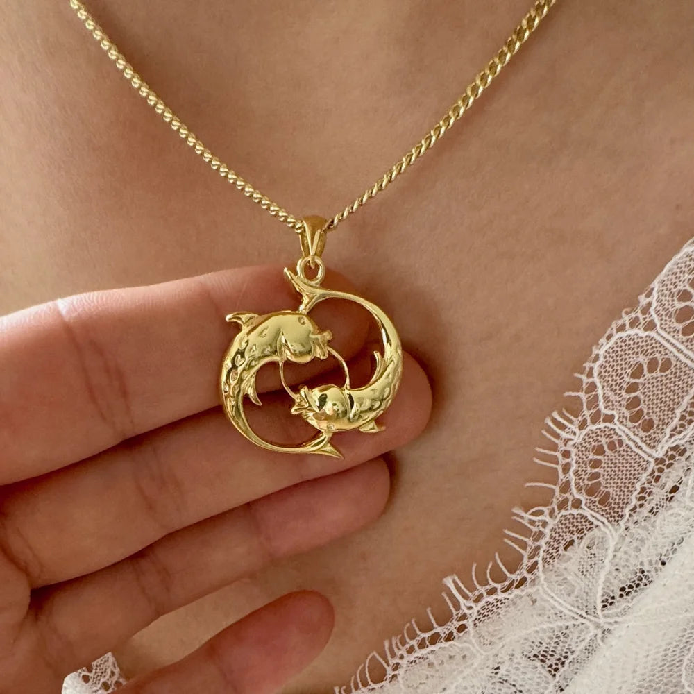 Gold dolphin pendant necklace, perfect for women, showcasing a playful design ideal for casual or beach occasions.