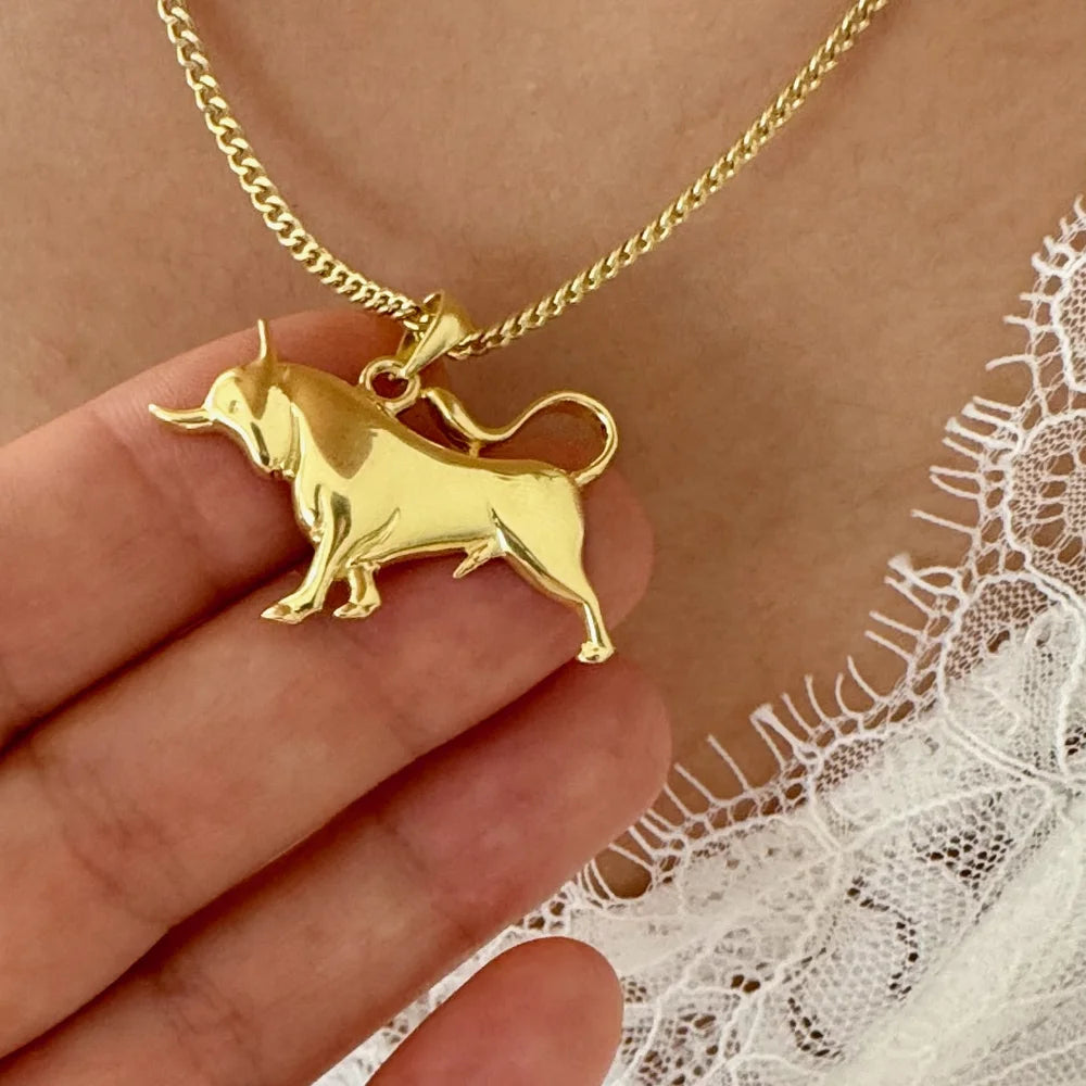 Gold bull pendant necklace on a delicate chain, perfect for women seeking a unique, minimalist accessory.