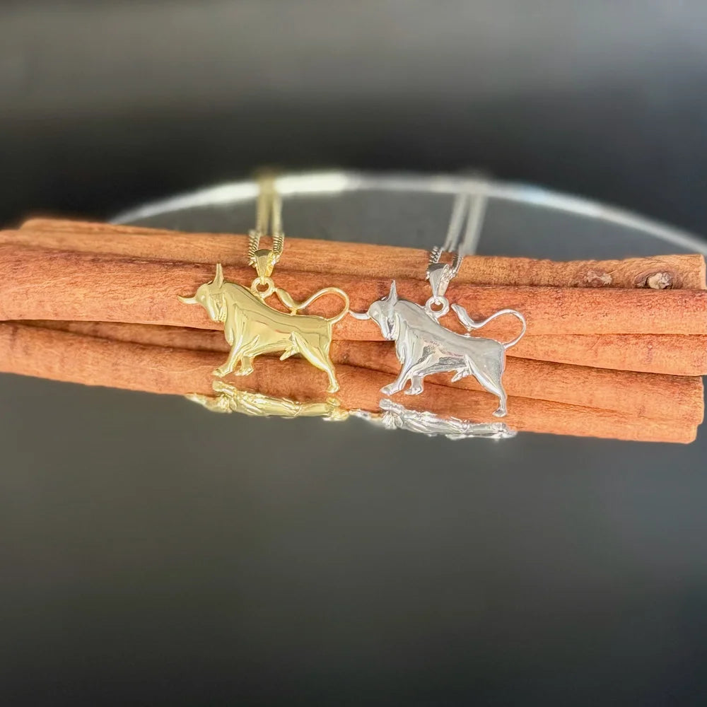 Golden and silver bull pendants on chains, perfect for men or women seeking stylish, minimalist animal jewelry.