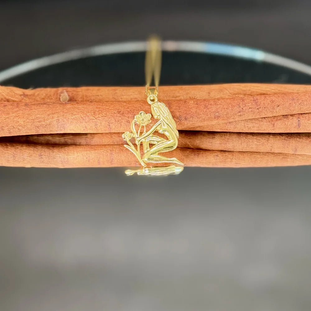Gold pendant necklace featuring a delicate woman and flower design, perfect for women who love vintage-inspired jewelry.