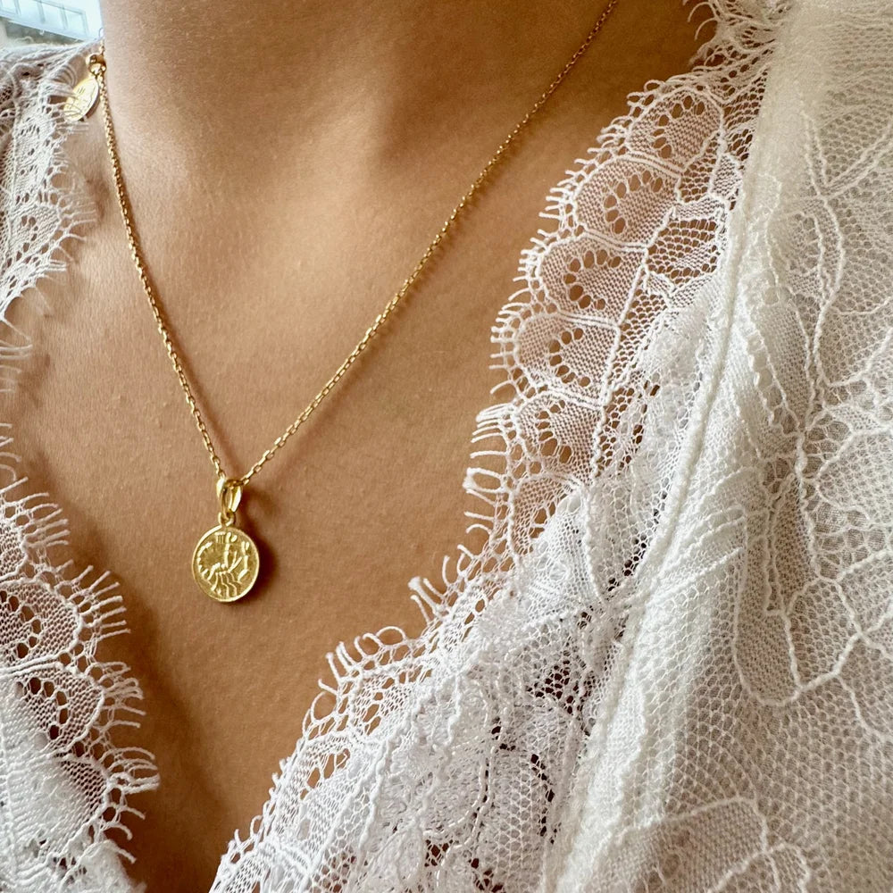 Gold pendant necklace with intricate design, perfect for women seeking a classic yet elegant accessory for any occasion.