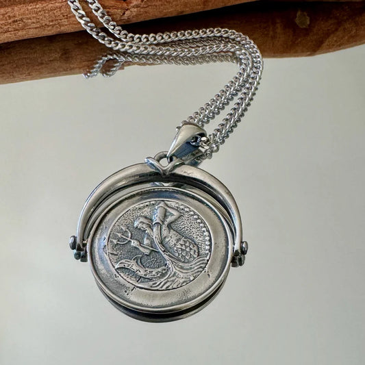 Vintage silver locket necklace featuring intricate ocean-themed design, perfect for women who appreciate unique, classic jewelry.