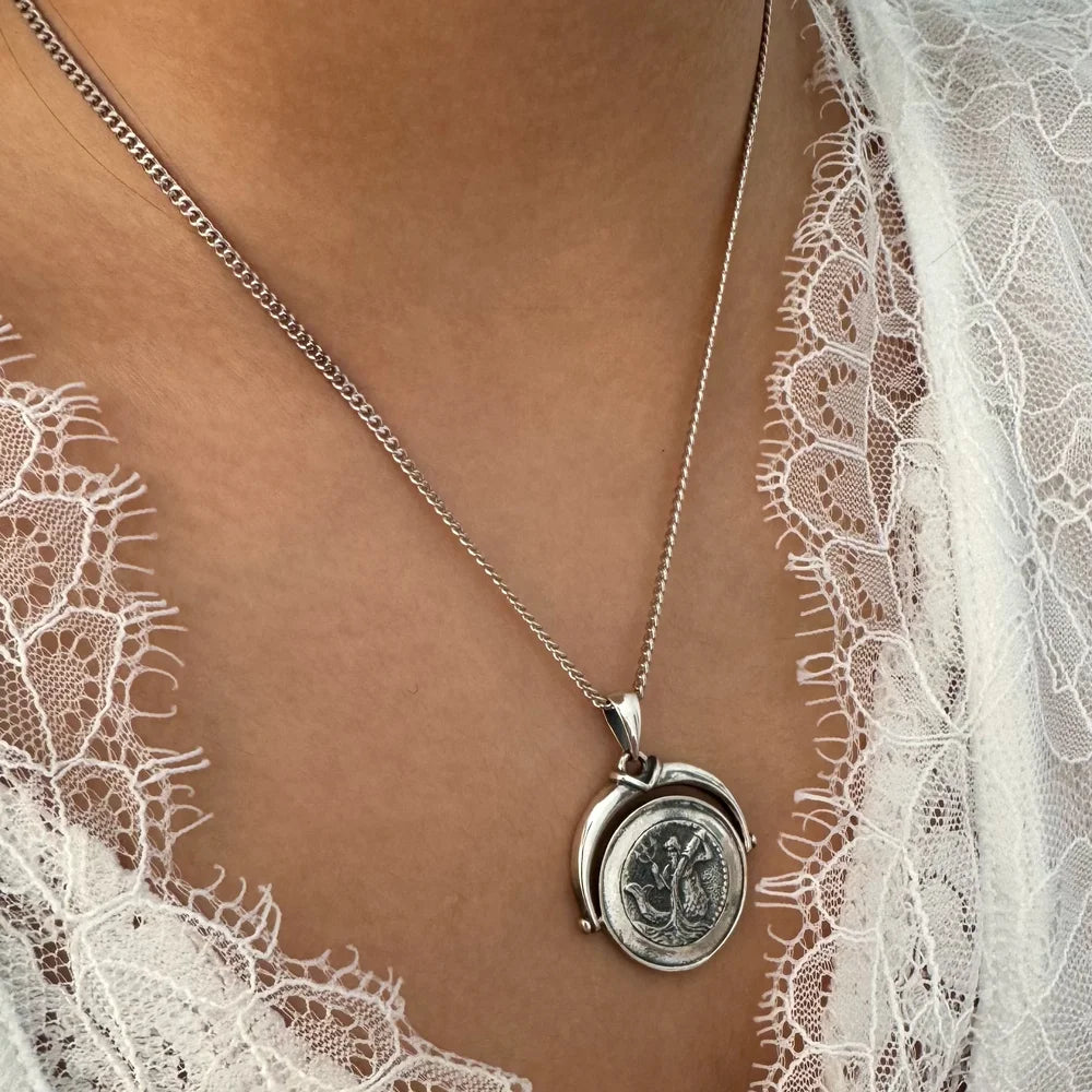 Sterling silver vintage pendant necklace featuring intricate design, ideal for women seeking a classic touch.