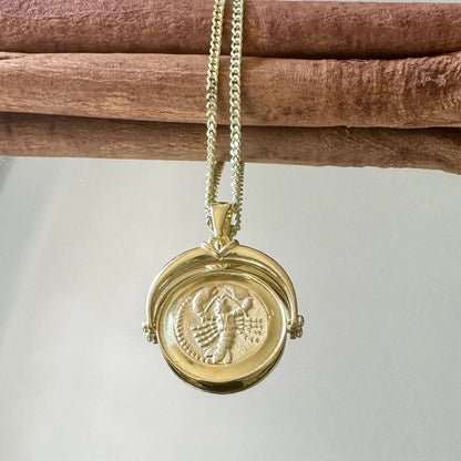 Gold vintage locket necklace features intricate engravings, perfect for women seeking a unique statement piece.