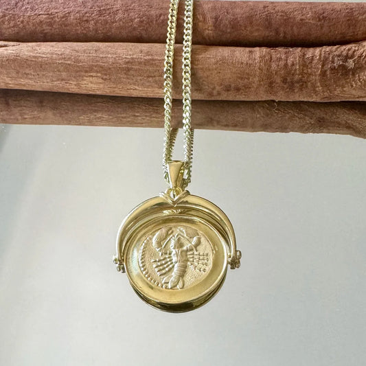 Gold vintage locket necklace features intricate engravings, perfect for women seeking a unique statement piece.