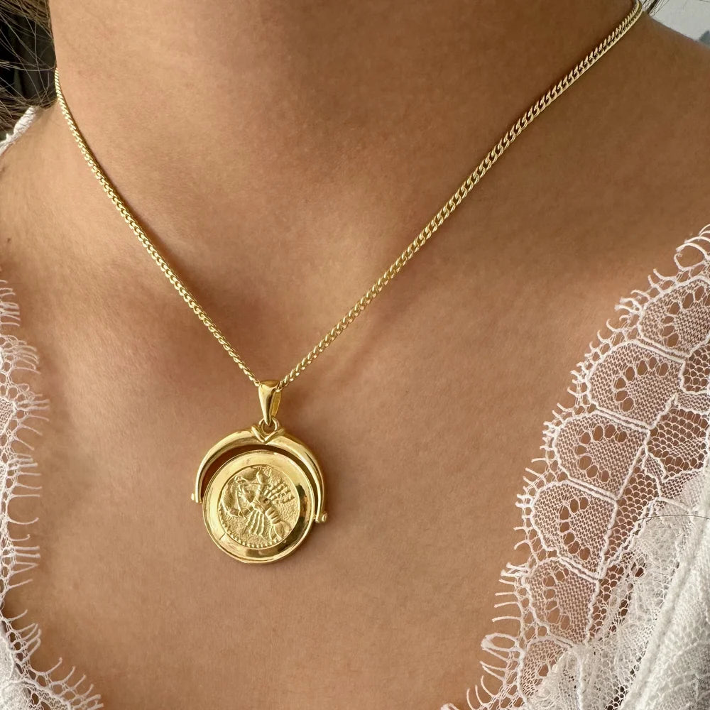 Gold pendant necklace with intricate design, perfect for women seeking a vintage style for special occasions.