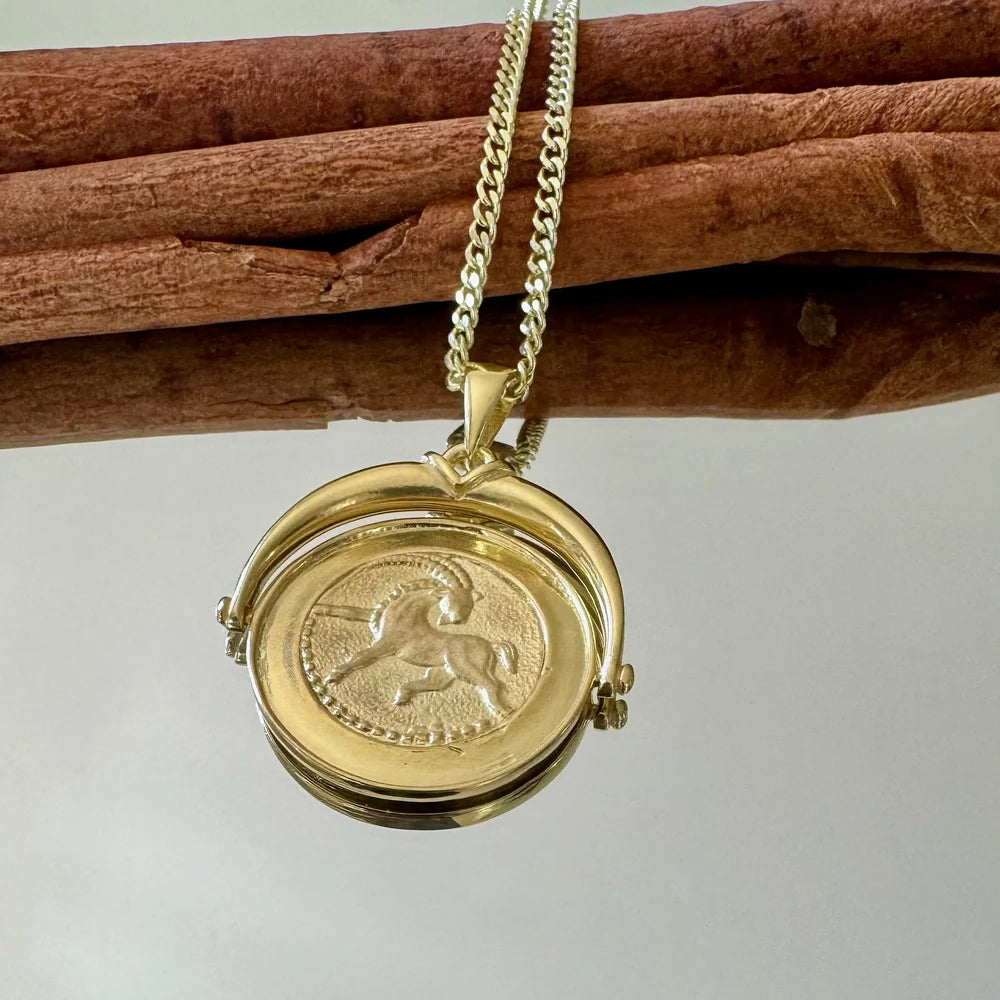 Gold zodiac pendant necklace featuring a Capricorn design, perfect for women who appreciate vintage charm and style.