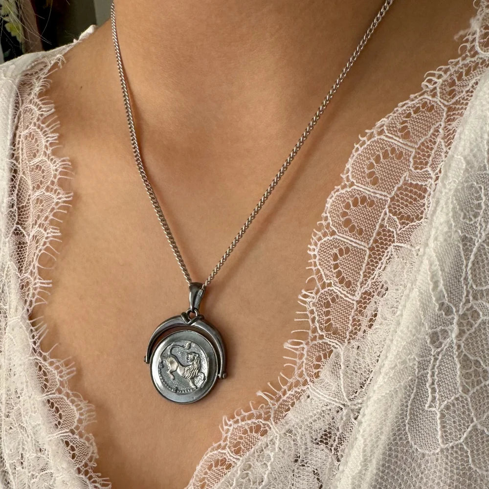 Silver lion medallion necklace on delicate chain, perfect for women seeking a vintage, bohemian style accessory.