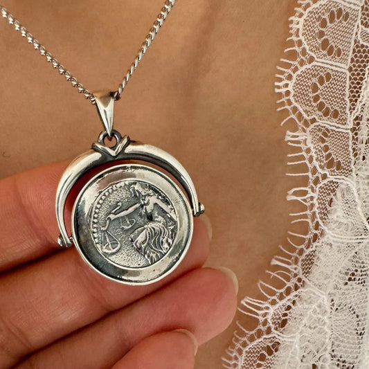 Sterling silver vintage necklace featuring a detailed coin pendant, perfect for women seeking a classic, elegant accessory.