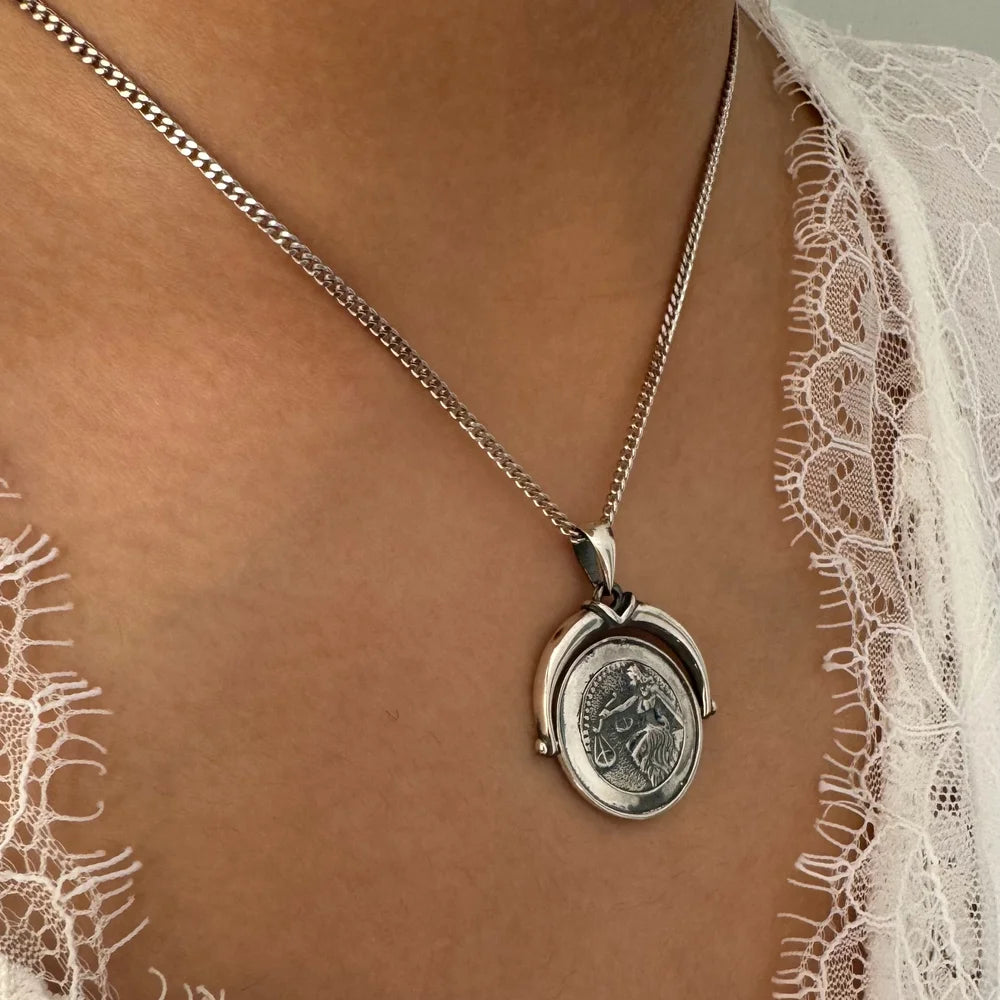 Silver pendant necklace featuring a vintage coin design, perfect for women seeking minimalist style for any occasion.