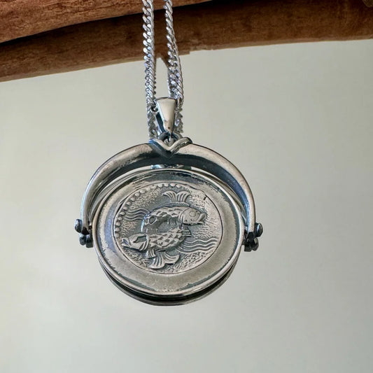 Silver fish pendant necklace with intricate detailing, perfect for women seeking a unique, vintage accessory.