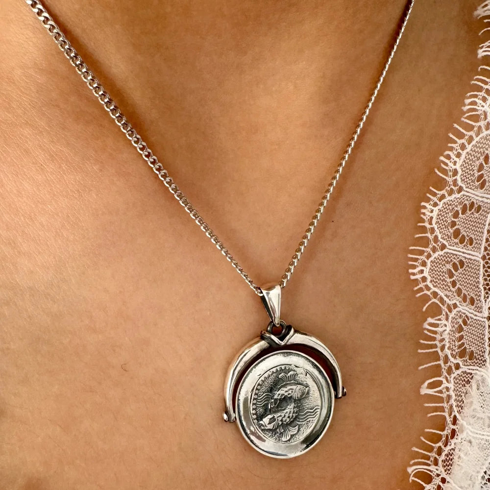 Sterling silver necklace featuring a textured coin pendant, perfect for women who love vintage-inspired jewelry.