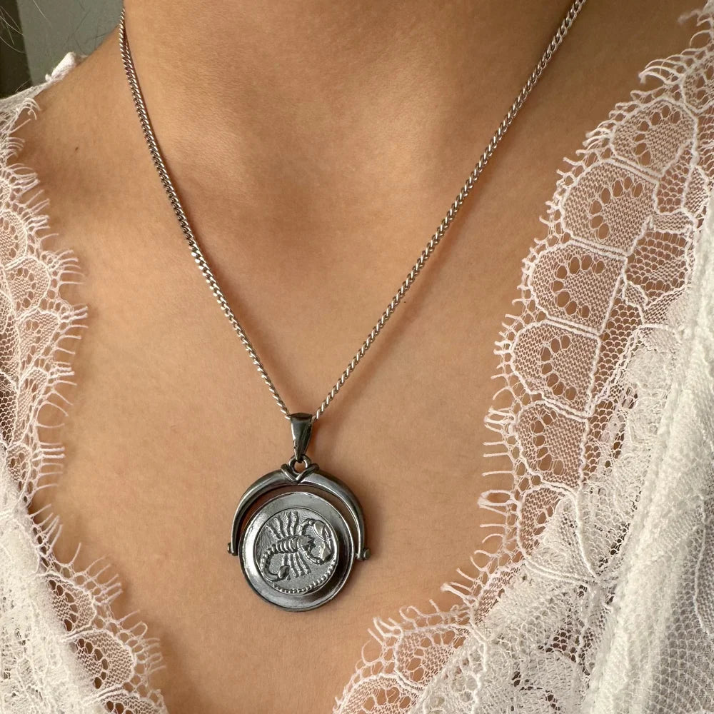 Silver vintage-inspired pendant necklace featuring a unique scorpion motif, perfect for women who love classic jewelry.