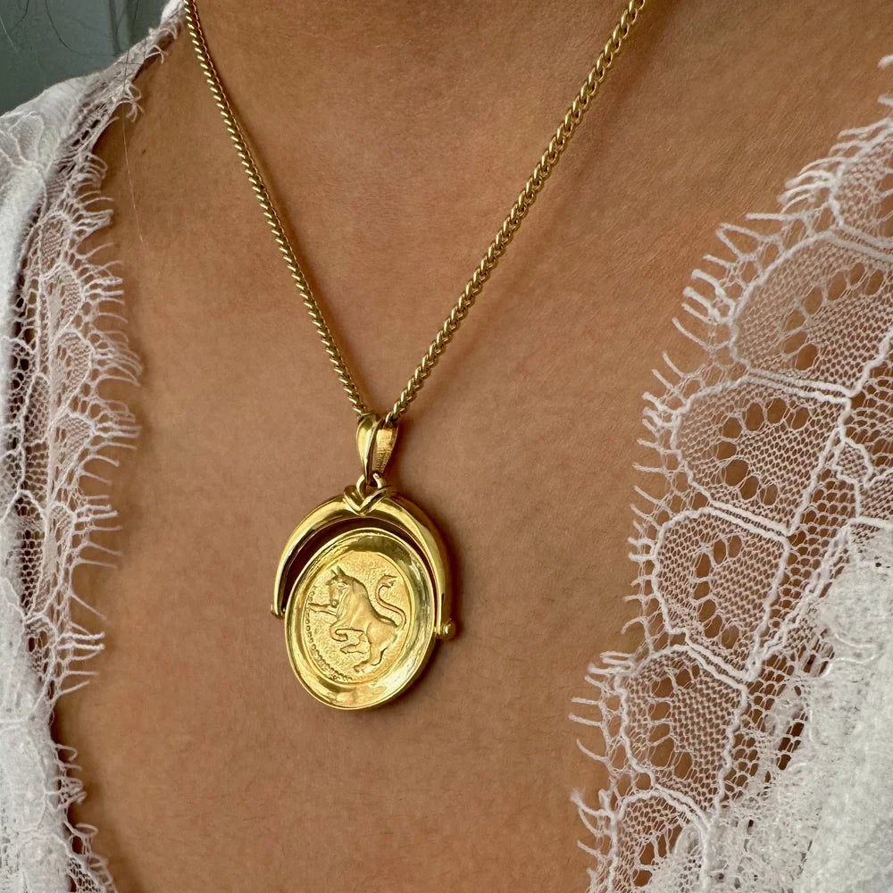 Golden unicorn pendant necklace with intricate detailing, perfect for women seeking a vintage-inspired accessory.