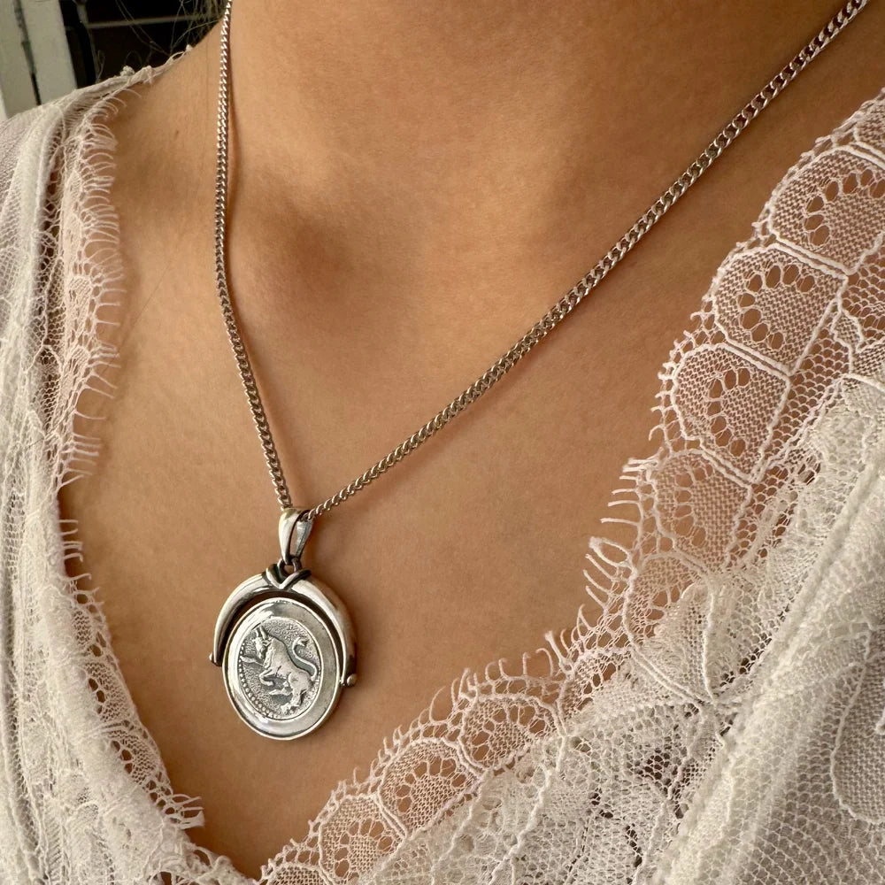 Sterling silver coin pendant necklace with intricate lion design, perfect for women seeking vintage elegance.