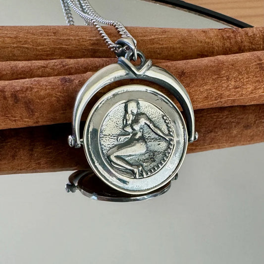 Silver pendant necklace featuring a vintage design, perfect for women seeking unique, artistic jewelry.