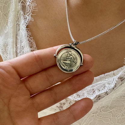 Vintage silver locket necklace featuring a detailed pendant, perfect for women seeking a classic, timeless accessory.
