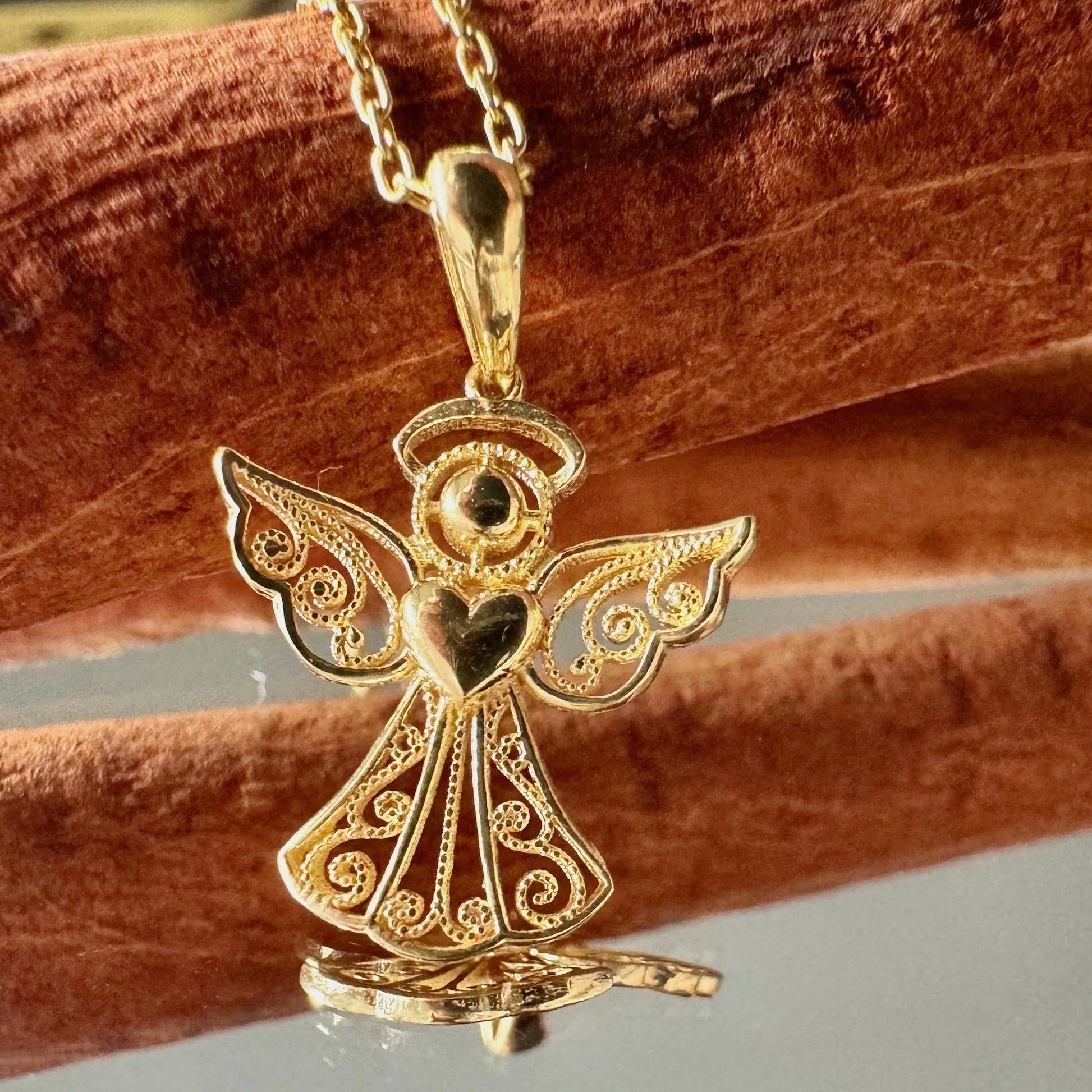 Delicate gold angel pendant necklace, perfect for women seeking a classic, meaningful accessory for special occasions.