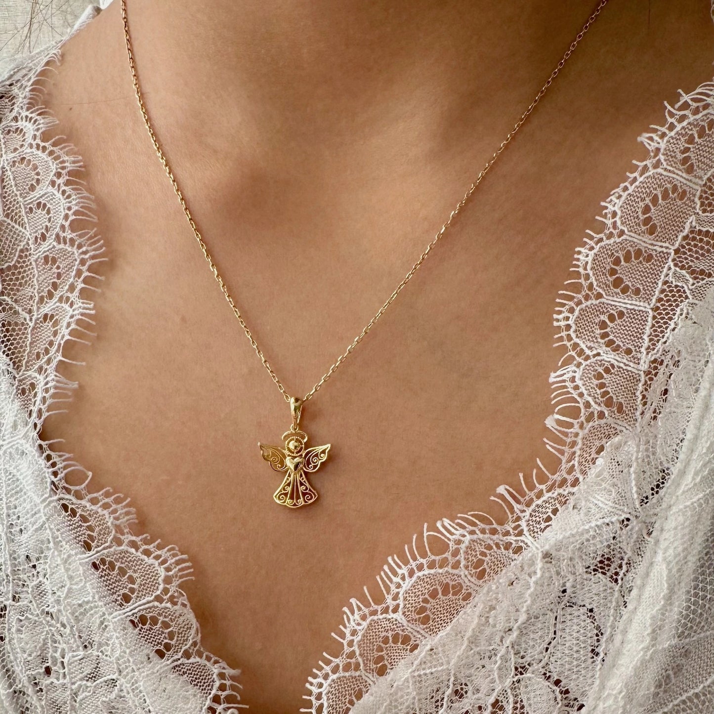 Delicate gold angel pendant necklace, perfect for women on special occasions or as a thoughtful gift.