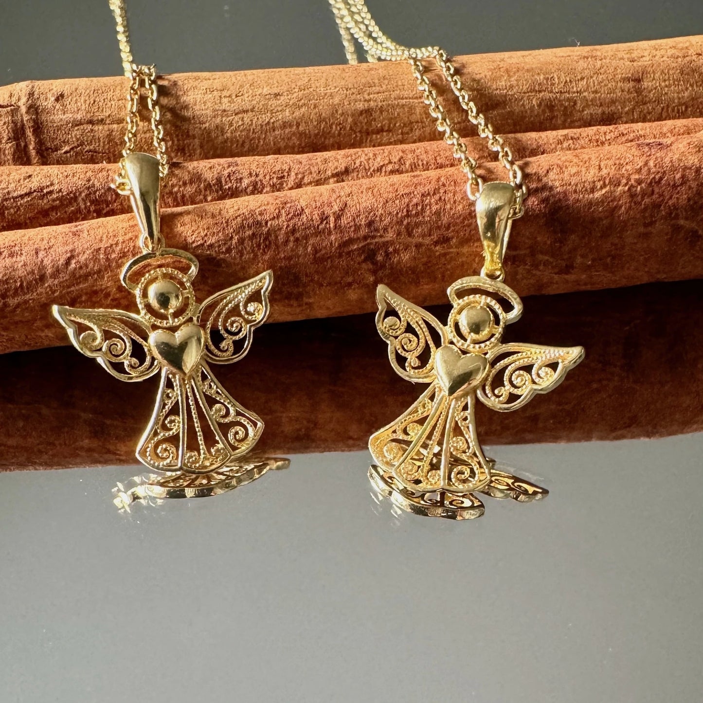 Intricate gold angel pendant necklace, perfect for women seeking a classic and meaningful accessory for any occasion.