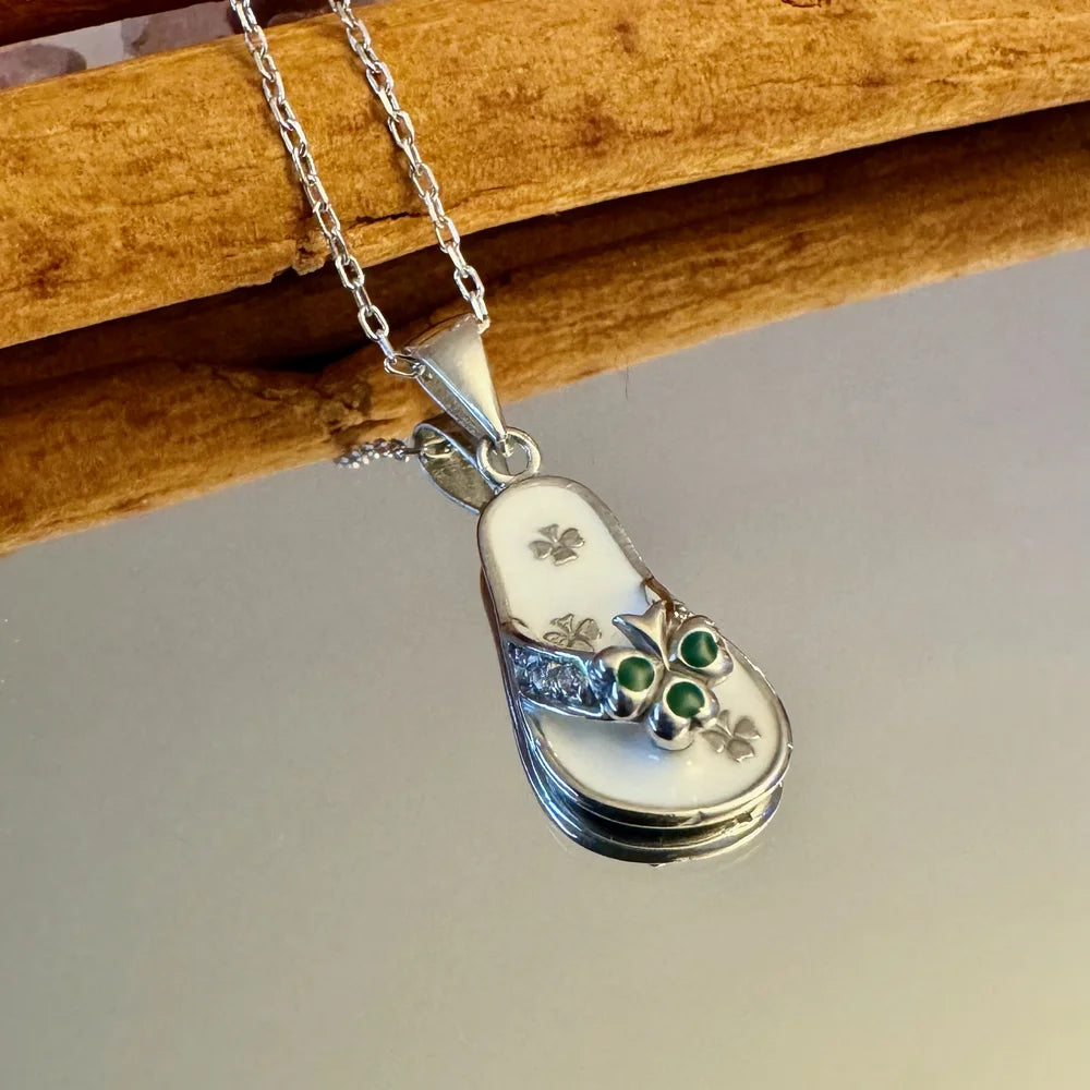 Silver flip-flop pendant necklace with green gemstones, perfect for women who love playful, beach-themed jewelry.