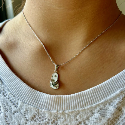 Delicate silver necklace featuring a floral pendant, perfect for women seeking a minimalist, elegant touch for casual occasions.