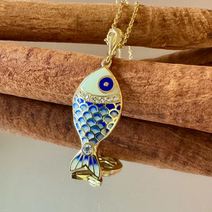 Gold fish pendant necklace with blue enamel and sparkling accents, perfect for women seeking a unique and stylish accessory.